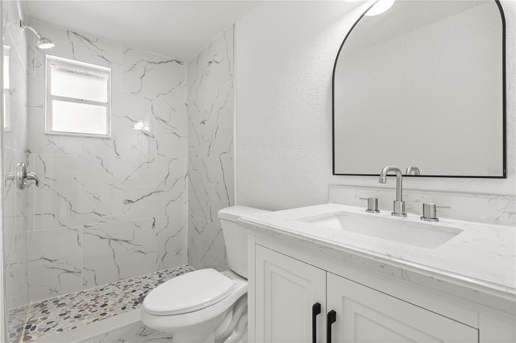 1251 Northwest 23rd Avenue Ocala, FL 34475 - Photo 20 of 34 a bathroom with a sink a toilet and shower