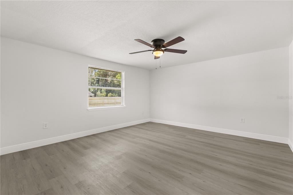 1251 Northwest 23rd Avenue Ocala, FL 34475 - Photo 22 of 34 a view of room with hardwood floor and ceiling fan