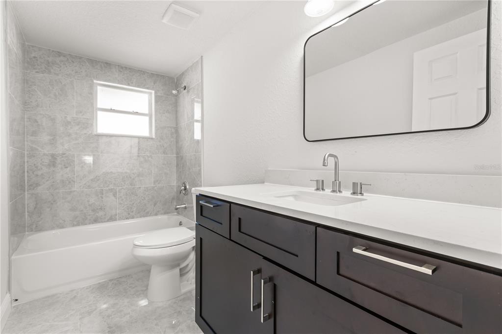 1251 Northwest 23rd Avenue Ocala, FL 34475 - Photo 23 of 34 a bathroom with a sink a toilet and bathtub