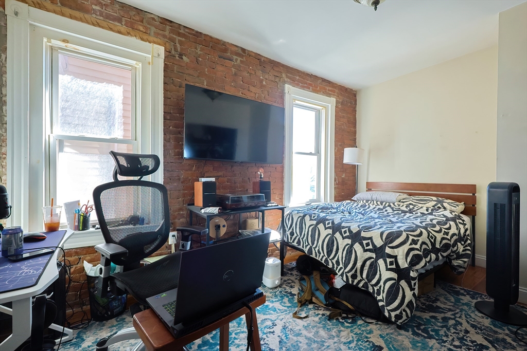 35 Adamson Street Boston, MA 02134 - Photo 12 of 41 a bedroom with a workspace