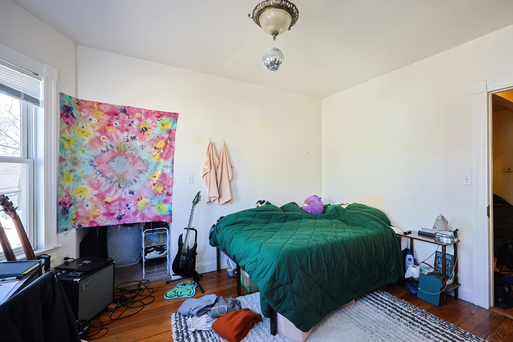 35 Adamson Street Boston, MA 02134 - Photo 16 of 41 a living room with a couch and a flat screen tv