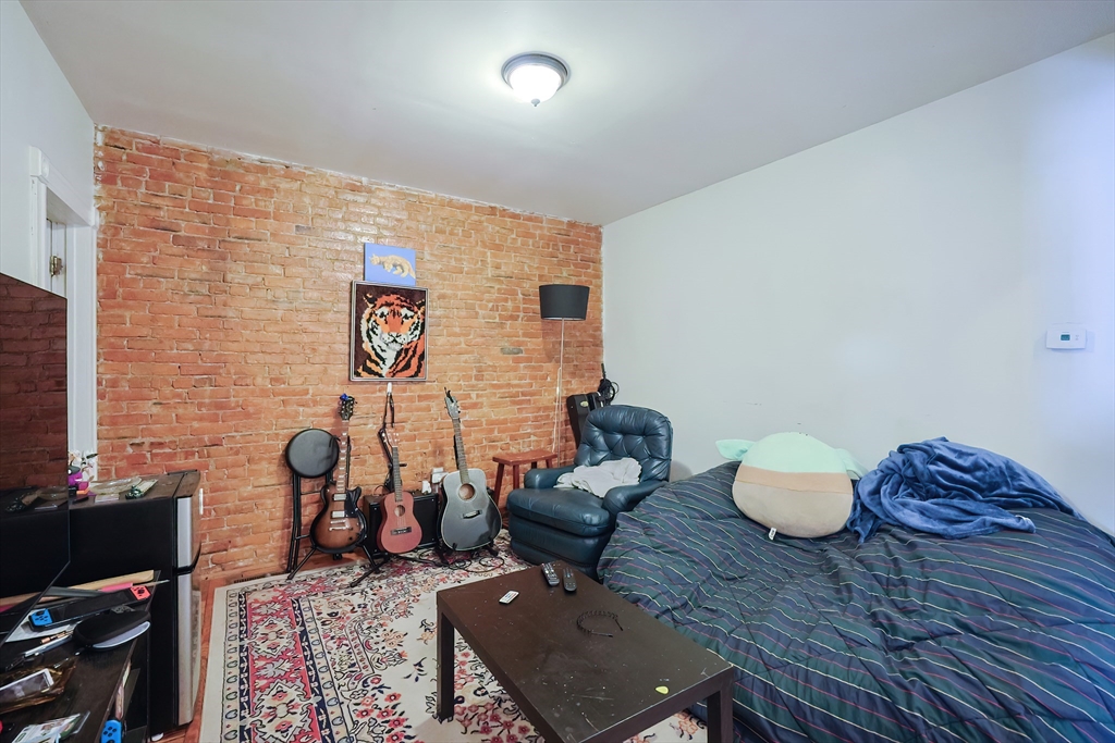 35 Adamson Street Boston, MA 02134 - Photo 18 of 41 a living room with furniture and a flat screen tv