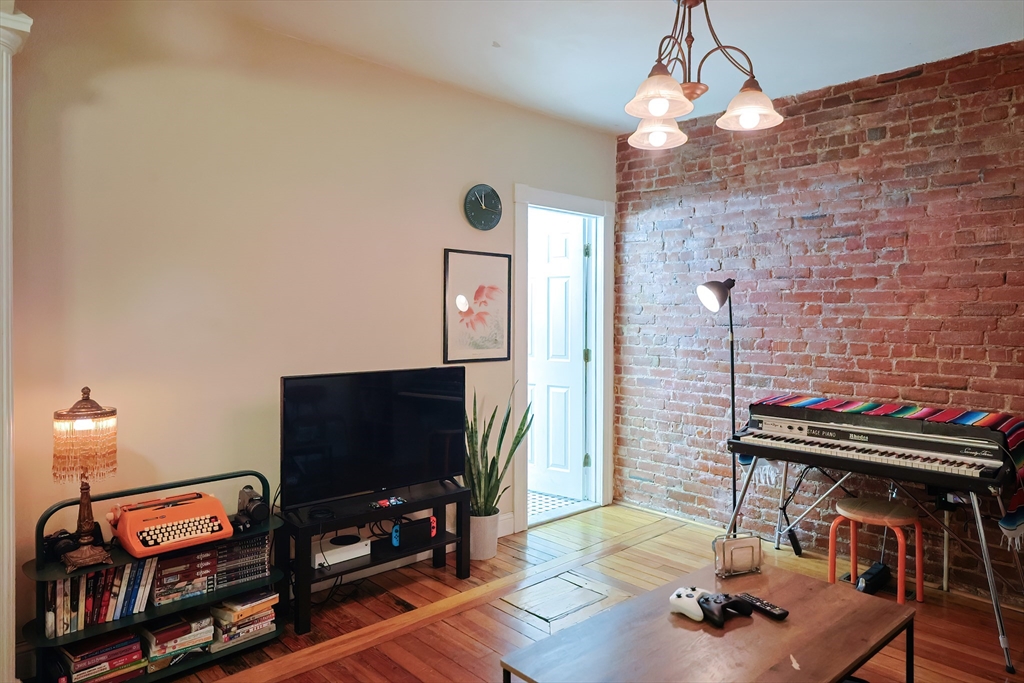35 Adamson Street Boston, MA 02134 - Photo 2 of 41 a living room with furniture and a flat screen tv