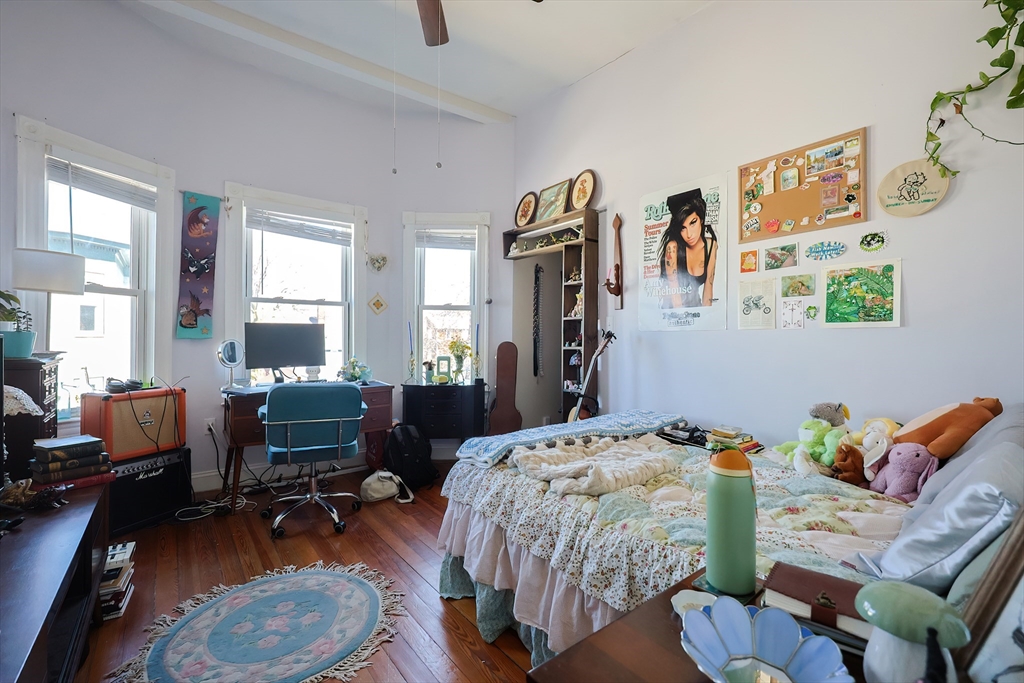 35 Adamson Street Boston, MA 02134 - Photo 26 of 41 a bedroom with a bed and a couch