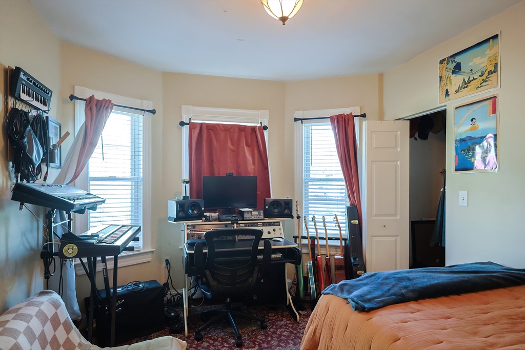 35 Adamson Street Boston, MA 02134 - Photo 3 of 41 a bedroom with a bed and a flat screen tv