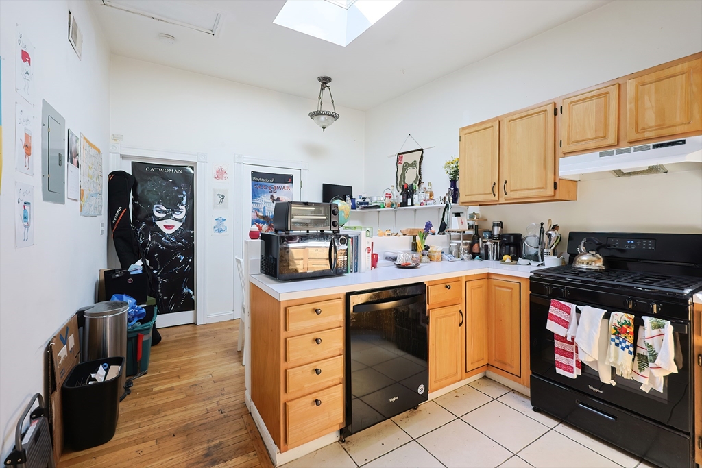 35 Adamson Street Boston, MA 02134 - Photo 34 of 41 a kitchen with stainless steel appliances granite countertop a stove top oven a sink dishwasher and cabinets with wooden floor