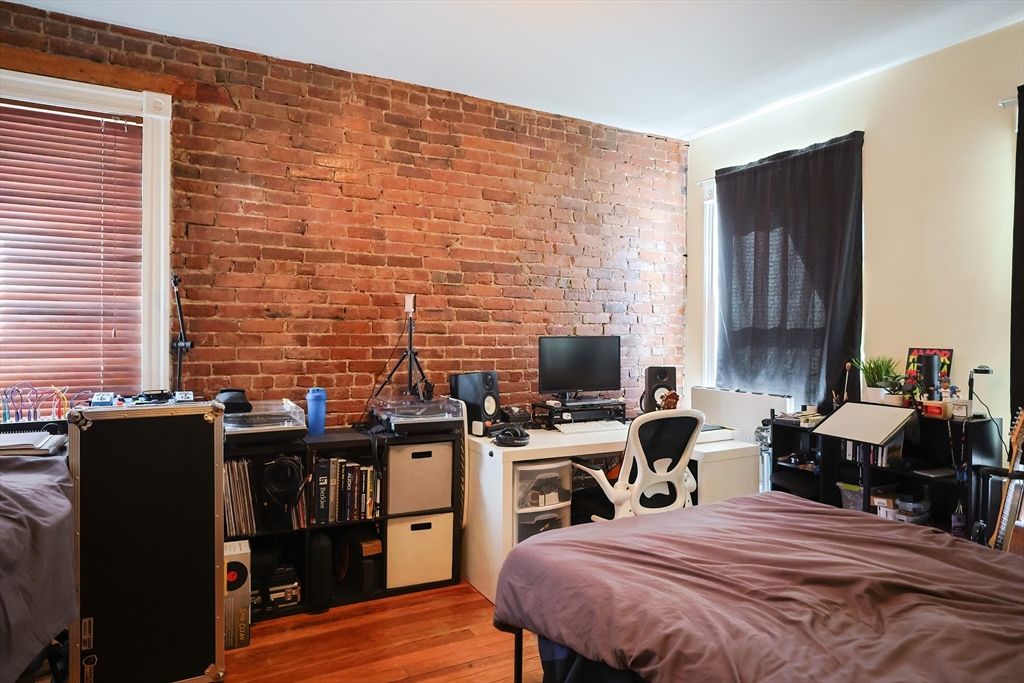 35 Adamson Street Boston, MA 02134 - Photo 4 of 41 a bedroom with a bed and a computer on the desk