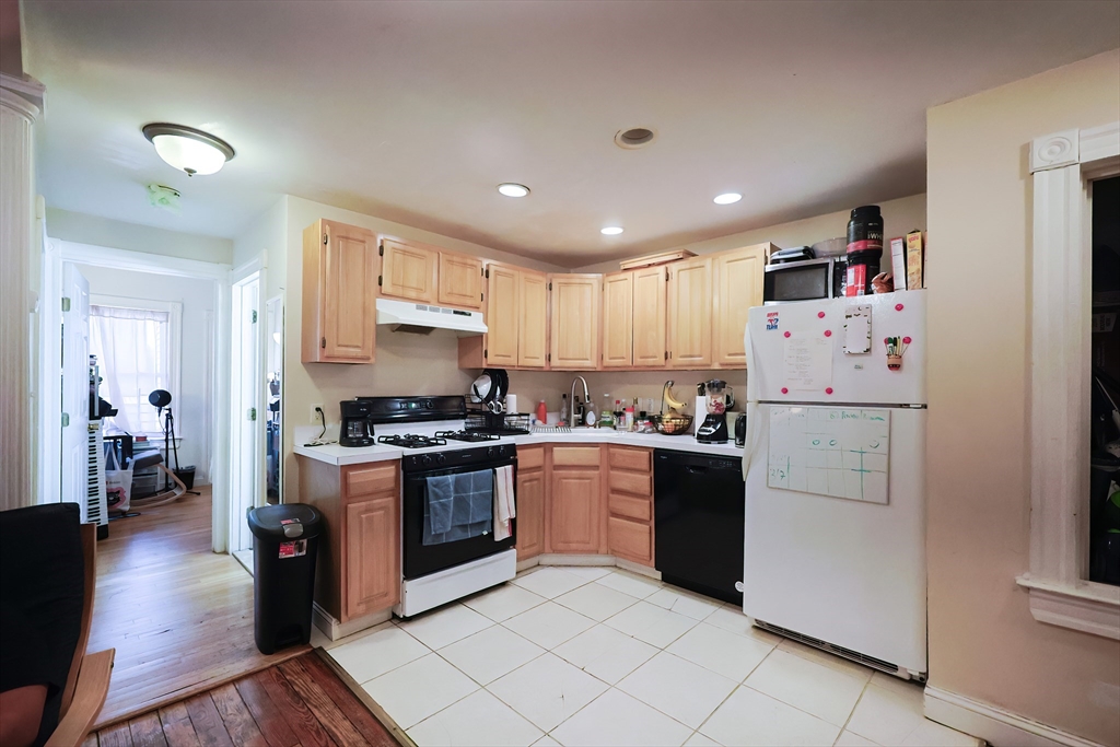 35 Adamson Street Boston, MA 02134 - Photo 9 of 41 a kitchen with cabinets and stainless steel appliances