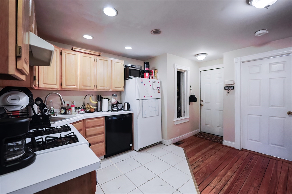 35 Adamson Street Boston, MA 02134 - Photo 10 of 41 a kitchen with stainless steel appliances a refrigerator stove and wooden floor