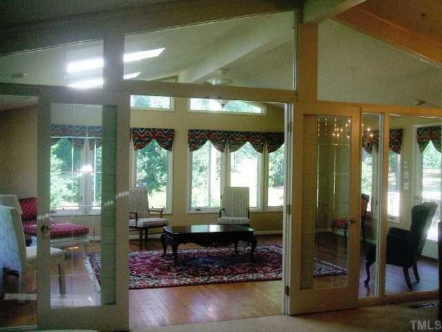 5301 Lead Mine Road Raleigh, NC 27612 - Photo 6 of 11 Looking from the living and dining area through the french doors, hardwoods below, sky lights in cathedral ceiling overhead.