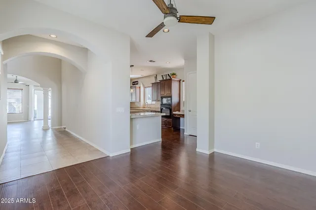 a kitchen with kitchen island granite countertop a sink cabinets and stainless steel appliances