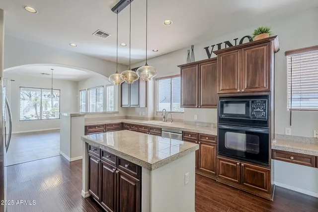 a kitchen with stainless steel appliances a stove a microwave and a sink