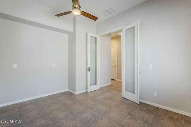 an empty room with a empty space and a ceiling fan