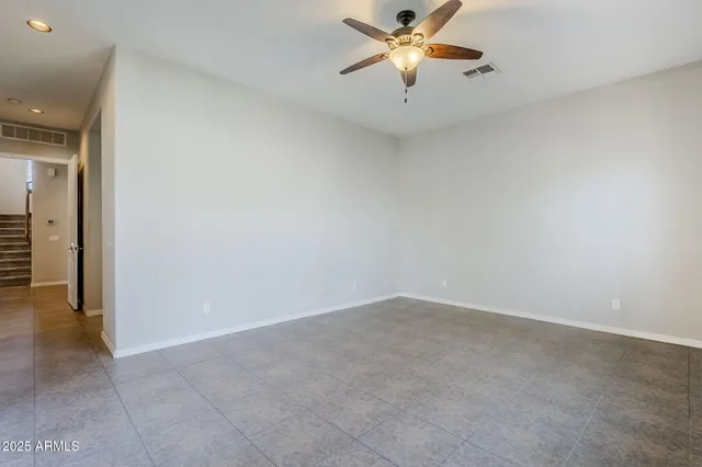 a spacious bathroom with a granite countertop double vanity sink a mirror and a bathtub
