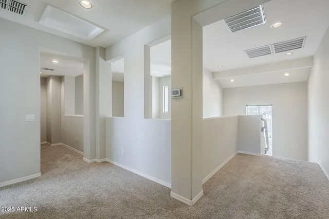 an empty room with a fan and a fan