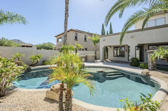 a view of a patio with couches under an umbrella