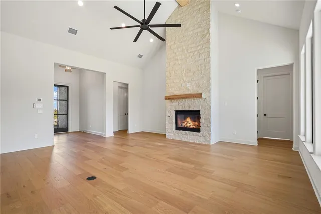 a view of an empty room with a fireplace and a window