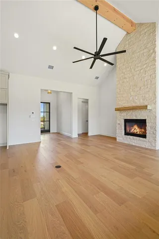 a view of empty room with a fireplace