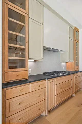 a kitchen with granite countertop cabinets and white stainless steel appliances