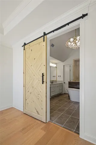 a view of a hallway with a dining table and a chandelier