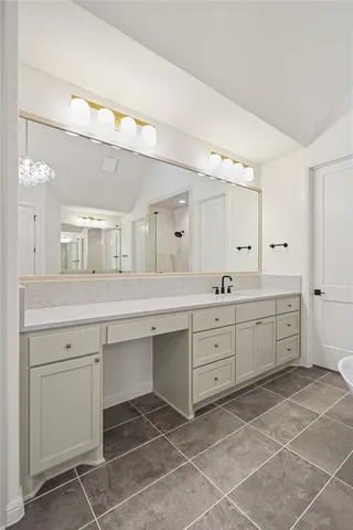 a spacious bathroom with a granite countertop sink mirror and a