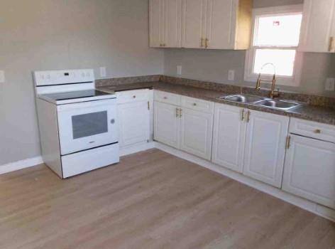 1195 Lawton Drive Macon, GA 31201 - Photo 6 of 11 a kitchen with granite countertop white cabinets and white appliances