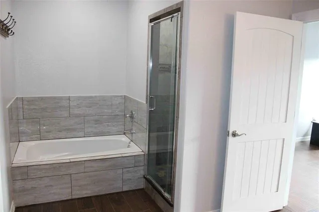 a bathroom with bathtub and shower