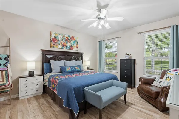 a bedroom with a bed and a chandelier