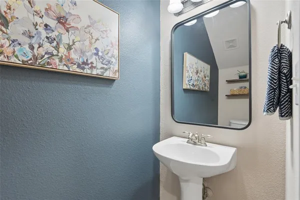 a bathroom with a sink toilet and shower curtain