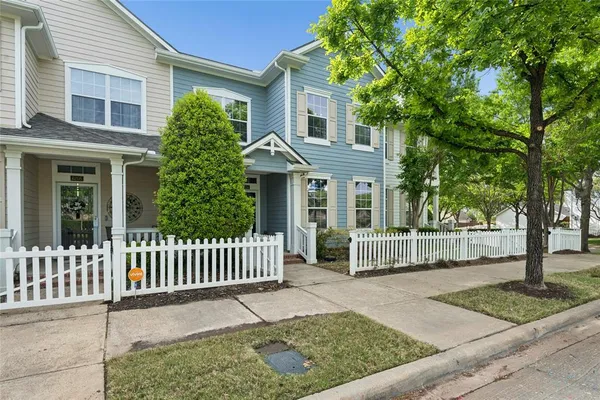 a living room with furniture and a dining table with kitchen view
