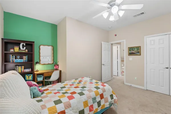 a street sign on a sidewalk next to a road