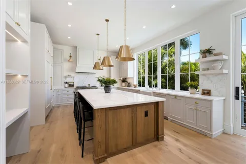 a view of a kitchen with a sink washer and dryer