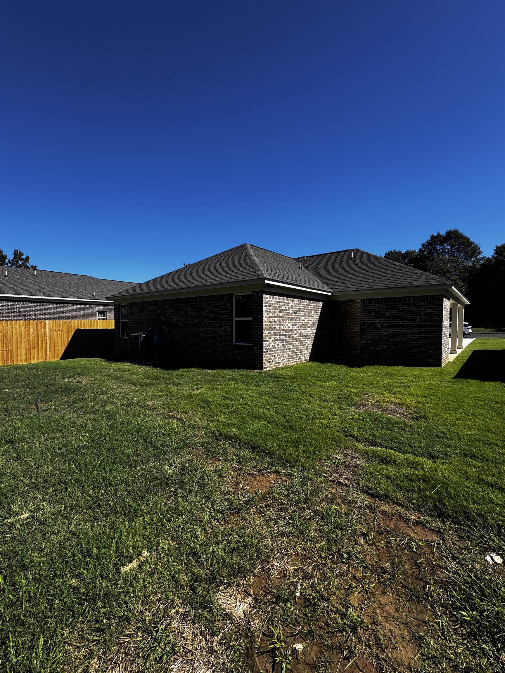 5243 Zodiac Road Memphis, TN 38118 - Photo 9 of 10 View of side of home with brick siding and roof with shingles