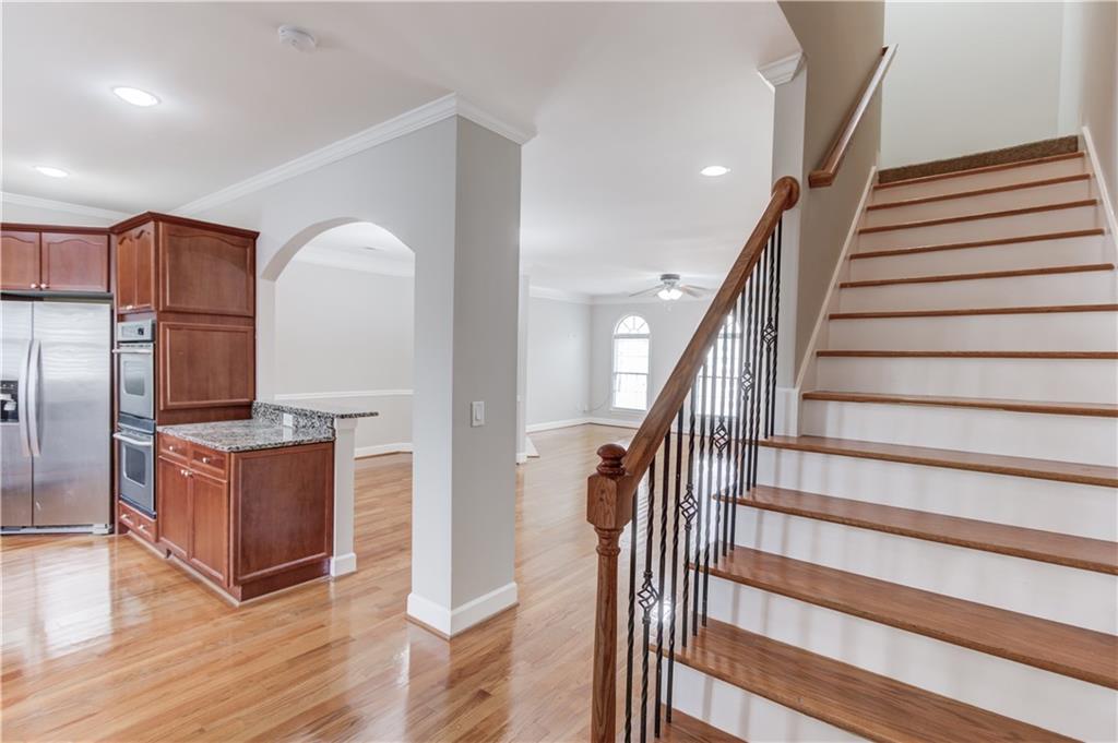 11007 Lorin Way Duluth, GA 30097 - Photo 17 of 30 a view of a kitchen with staircase and electronic appliances