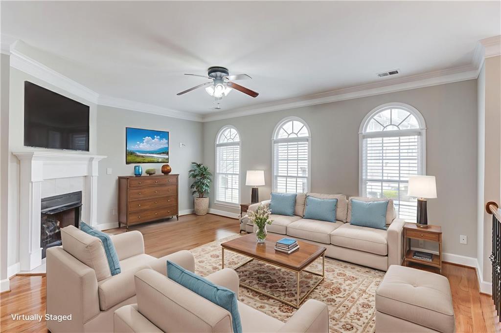 11007 Lorin Way Duluth, GA 30097 - Photo 3 of 30 a living room with furniture a fireplace and a flat screen tv