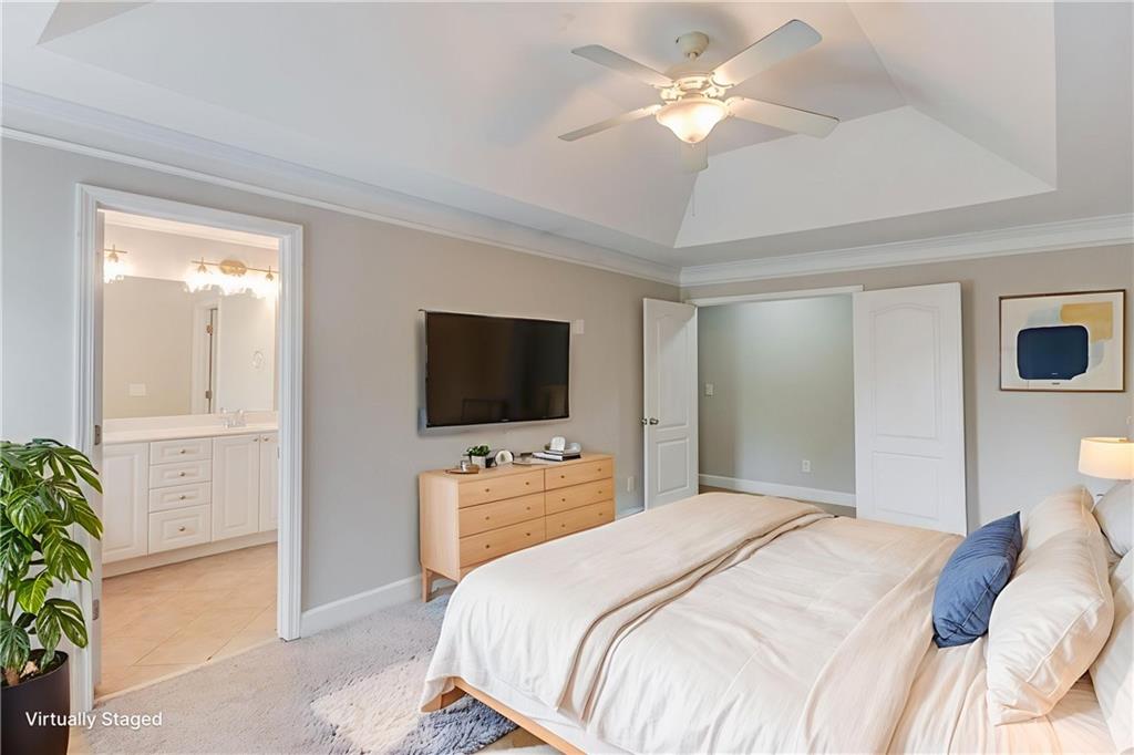 11007 Lorin Way Duluth, GA 30097 - Photo 5 of 30 a bedroom with a bed and a flat screen tv