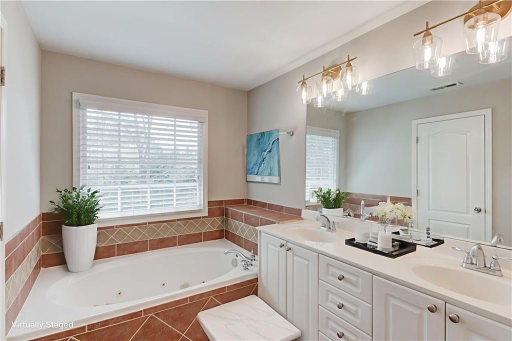11007 Lorin Way Duluth, GA 30097 - Photo 6 of 30 a bathroom with a tub sink and mirror