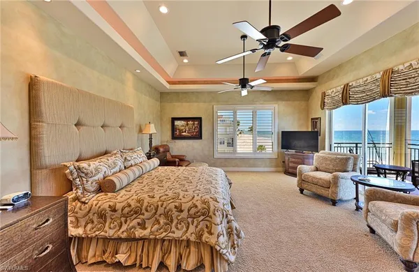 a spacious bedroom with a bed window and couch