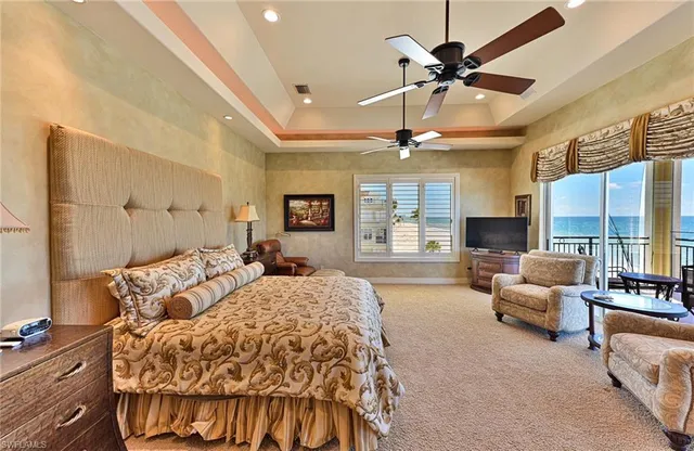 a spacious bedroom with a bed window and couch