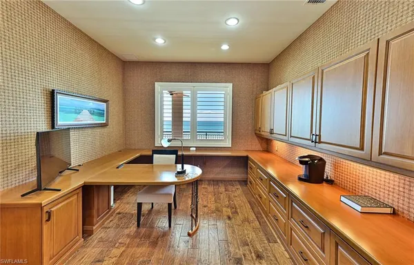 a view of a a dining room with furniture window and wooden floor