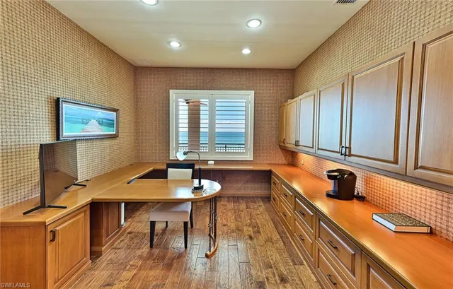 a view of a a dining room with furniture window and wooden floor