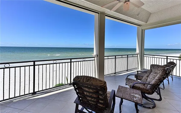 a balcony with table and chairs