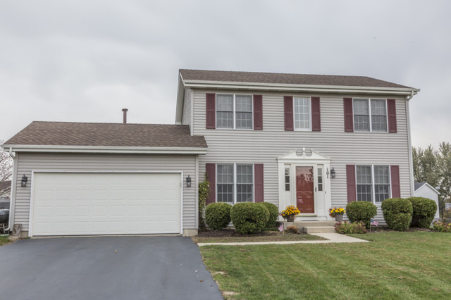 101 Barnes Road Elgin, IL 60124 - Photo 1 of 22 a front view of a house with a yard and garage