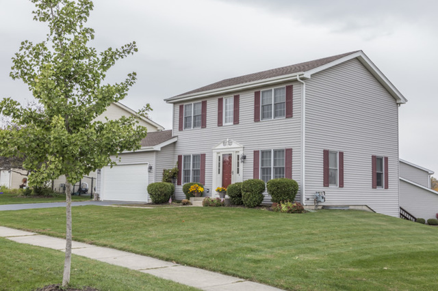 101 Barnes Road Elgin, IL 60124 - Photo 2 of 22 a front view of house with a garden