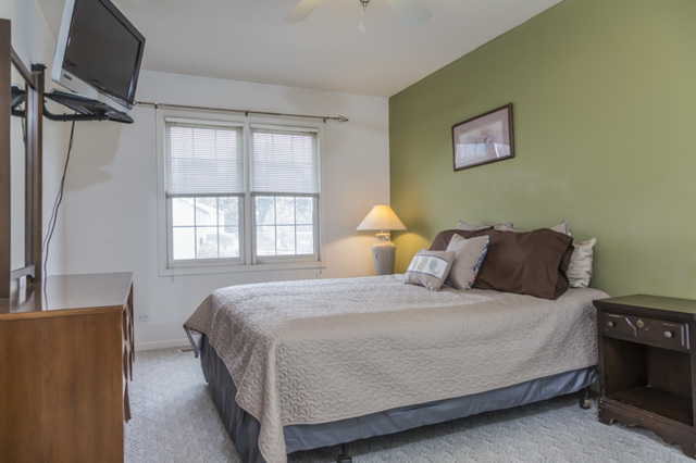 101 Barnes Road Elgin, IL 60124 - Photo 11 of 22 a bedroom with a bed and a window