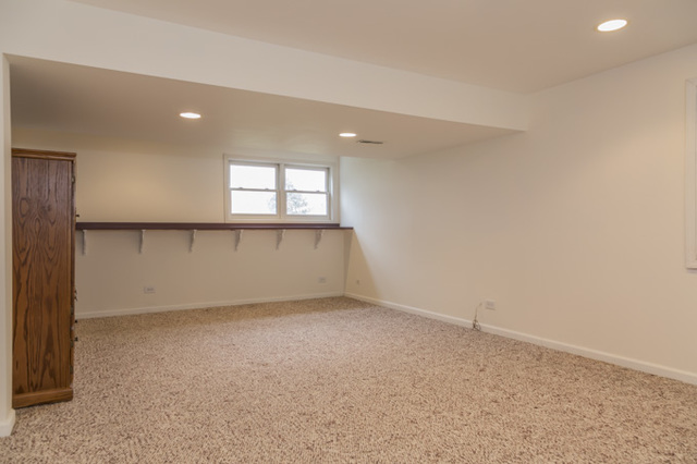 101 Barnes Road Elgin, IL 60124 - Photo 17 of 22 an empty room with a empty space and windows