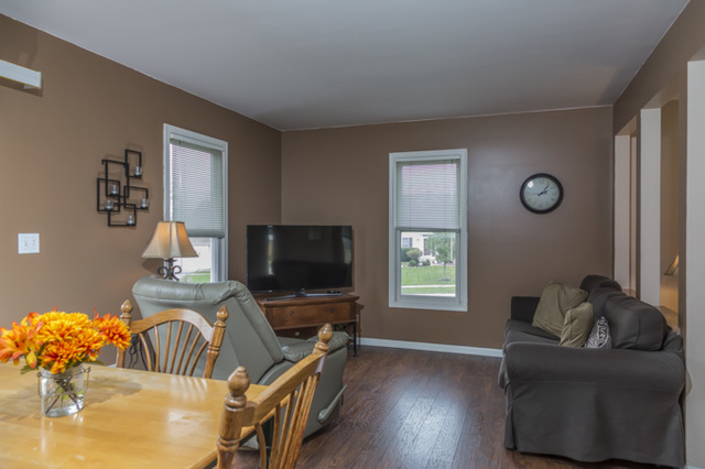 101 Barnes Road Elgin, IL 60124 - Photo 7 of 22 a bedroom with furniture and a flat screen tv