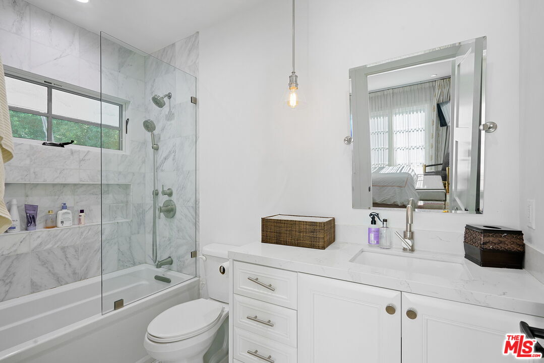 1738 Nichols Canyon Road Los Angeles, CA 90046 - Photo 21 of 25 a bathroom with a tub shower sink vanity and toilet
