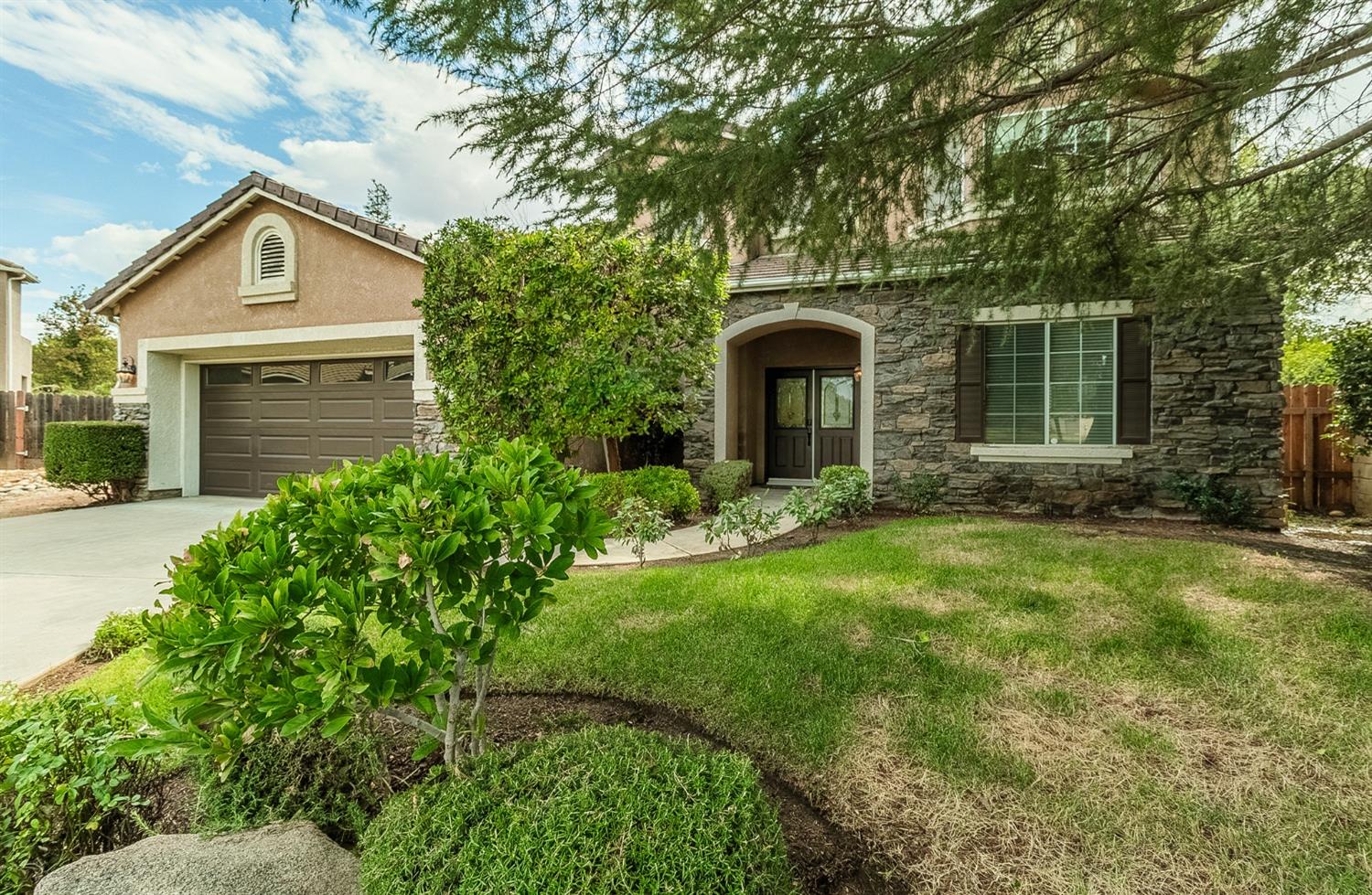 2595 Powers Avenue Coalinga, CA 93210 - Photo 1 of 34 a front view of a house with garden