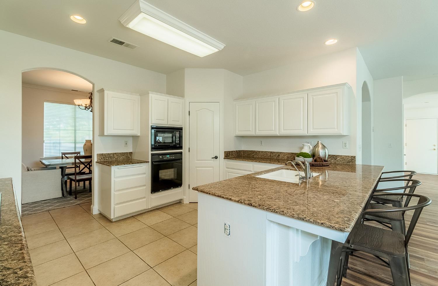 2595 Powers Avenue Coalinga, CA 93210 - Photo 11 of 34 a kitchen with a refrigerator a stove top oven a sink and dishwasher